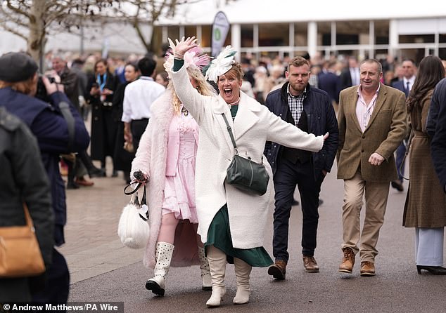 A woman greets fellow attendees enthusiastically