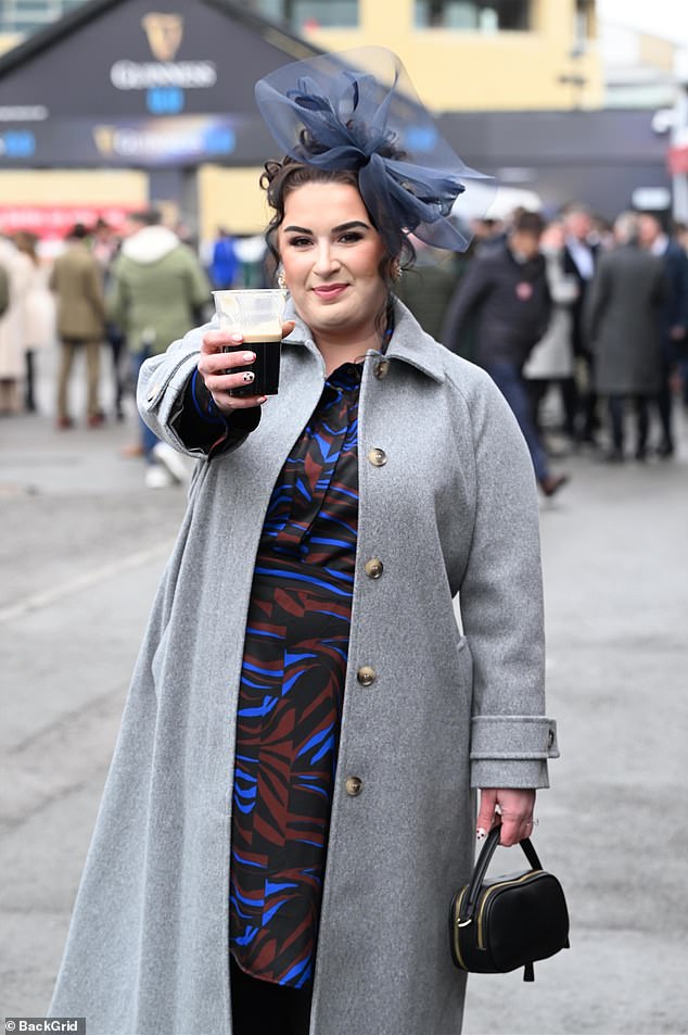 Another attendee raises her glass of Guinness as day two of the prestigious four-day event gets underway