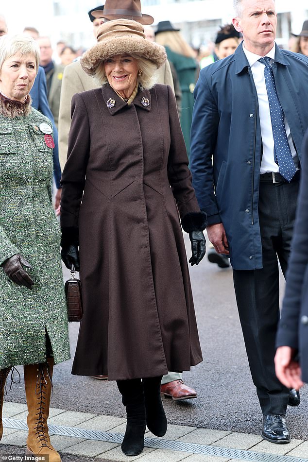 Queen Camilla appeared in beaming spirits as she arrived in a more muted display, with a thick tailored dress