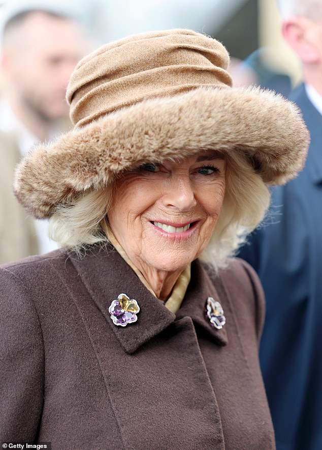Camilla wore a stunning faux fur-rimmed hat from Lock&Co and added a double pansy brooch