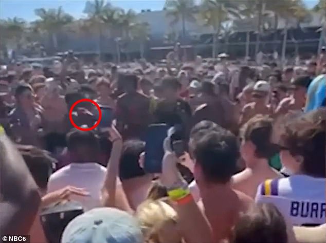 Moments after the two fighters touched gloves, they began throwing punches. Above, a boxing glove (circled) is seen connecting with the face of one of the men