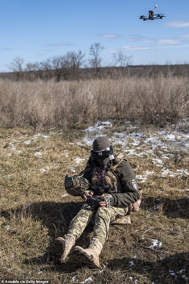 A soldier from the 42nd Brigade's kamikaze drone unit controls a BC drone for testing before deployment to the frontline in the Kharkiv region, Ukraine, on March 19, 2025