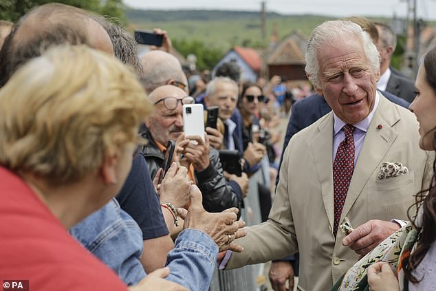 Charles seen meeting with heritage workers in Viscri during a private visit to Romania in 2023