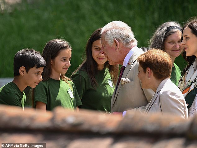 King Charles greets children as he exits the fortified evangelical church in the village of Viscri, central Transylvania, Romania, in 2023