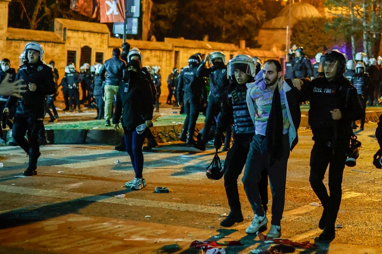 Turkish police officers try to detain a protester during a rally in support of arrested Istanbul’s mayor Ekrem Imamoglu, in Istanbul on March 23, 2025. Istanbul's newly-deposed mayor Ekrem Imamoglu was taken to a jail on the western outskirts of the megacity city on March 23, 2025 afternoon, the main CHP opposition party said. (Photo by KEMAL ASLAN / AFP)