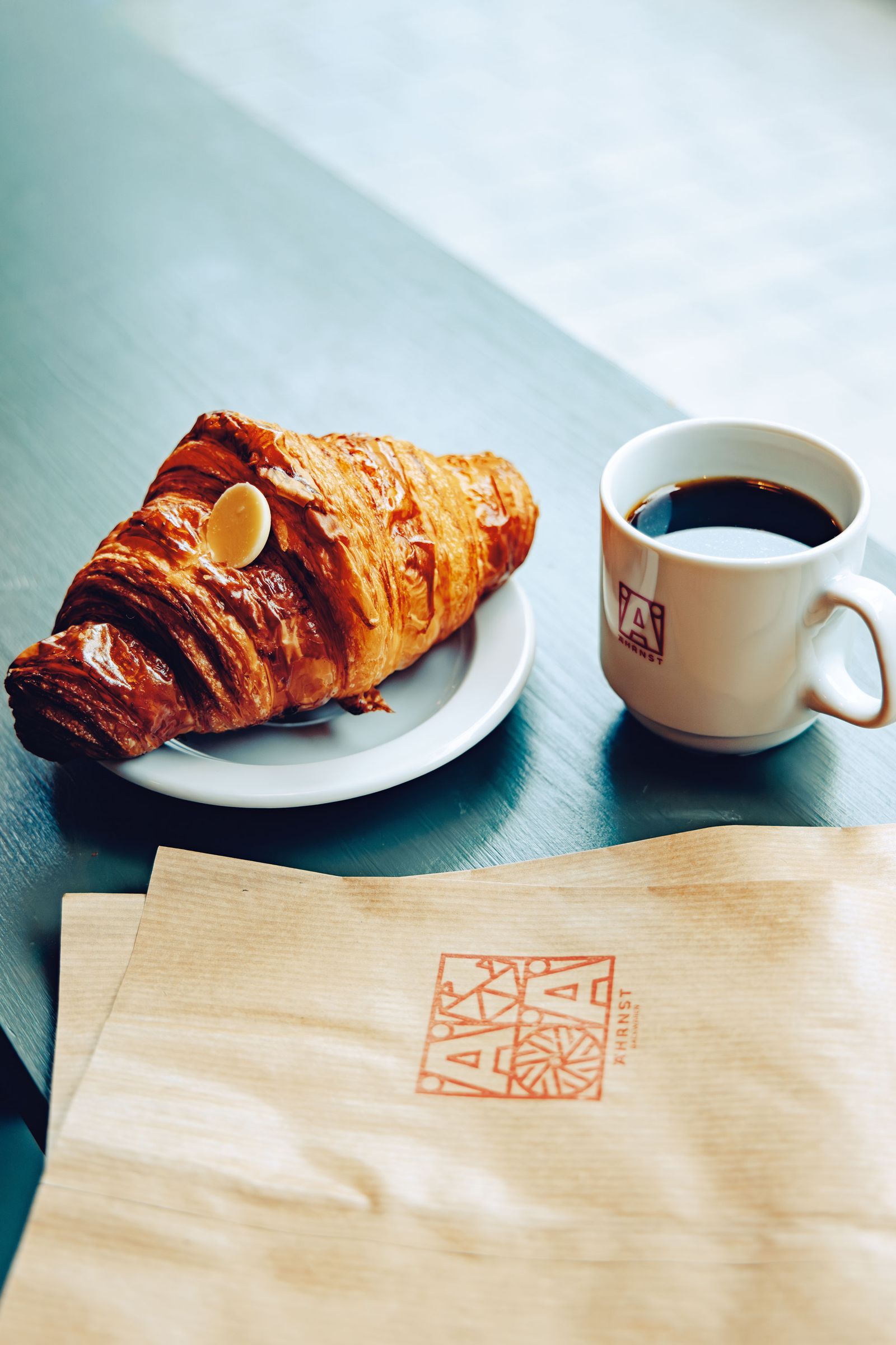 Image may contain Cup Bread Food Croissant and Plate