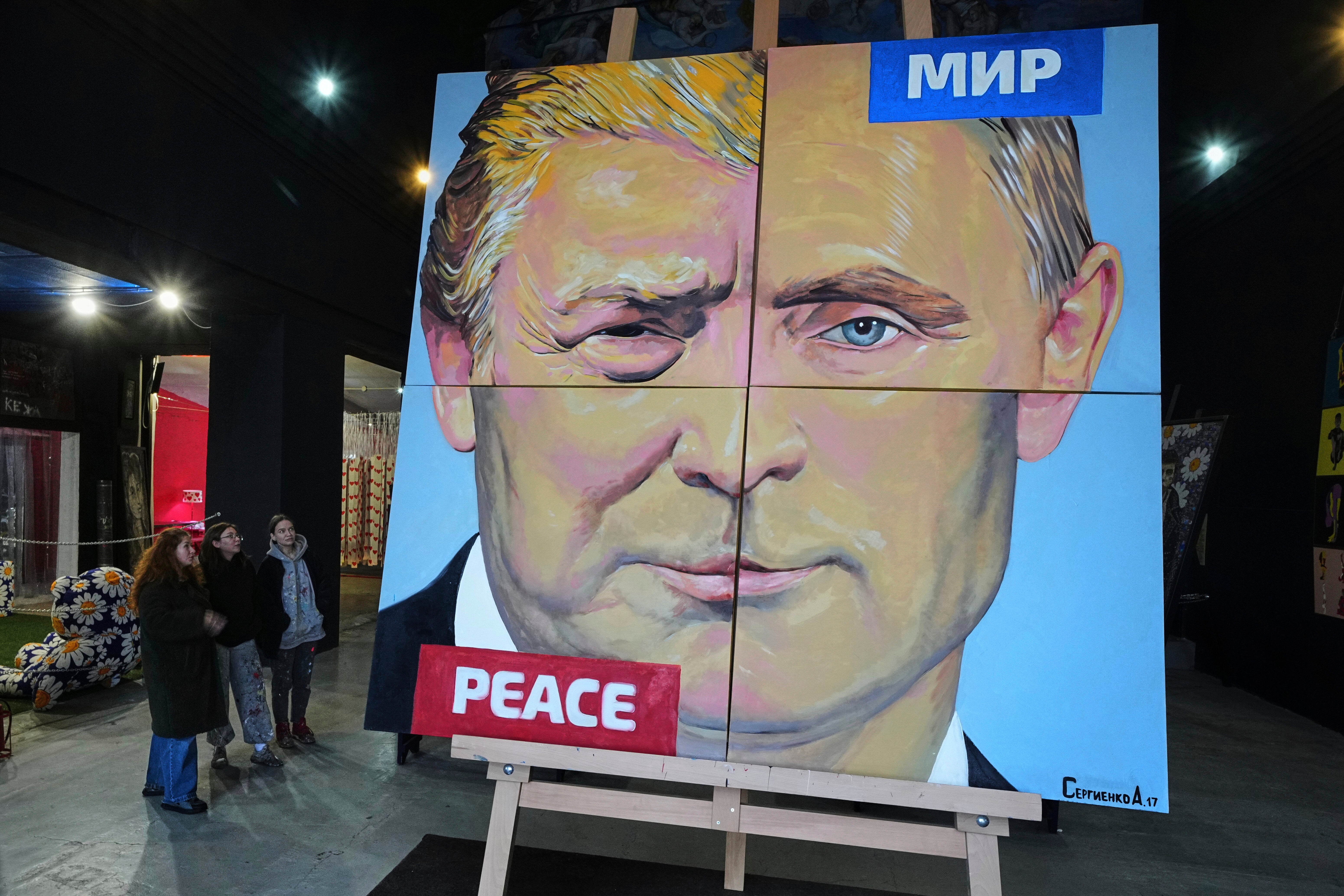 ‘Peace to the world’, a painting created by Russian artist Alexei Sergienko showing a combination of faces of Russian president Vladimir Putin and US president Donald Trump, is on display at the Sergienko's gallery in St. Petersburg, Russia