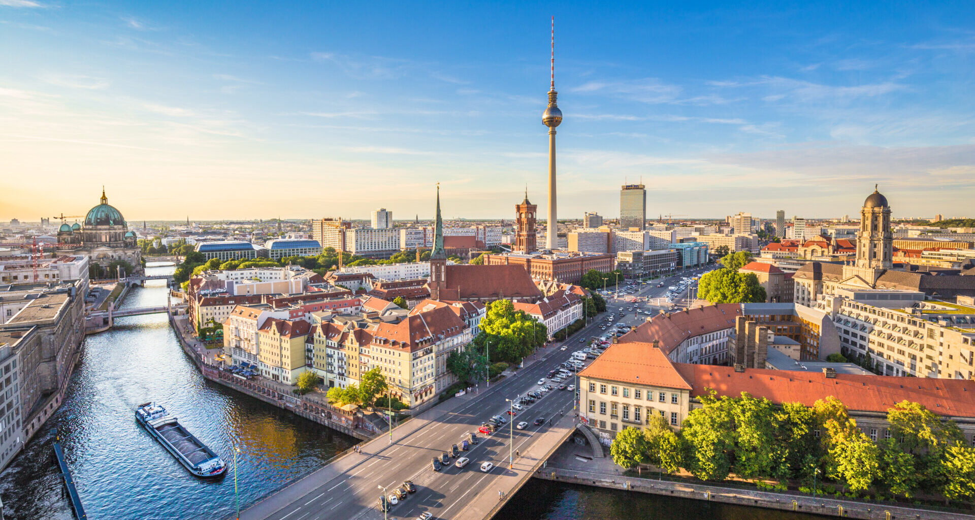 Berlin skyline panorama with TV tower and Spree river at sunset,