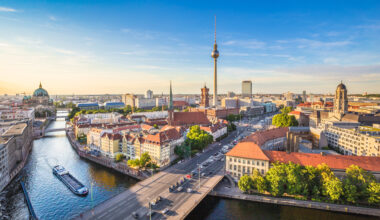 Berlin skyline panorama with TV tower and Spree river at sunset,