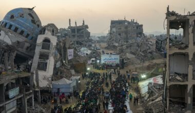 Surrounded by destroyed homes and buildings, Palestinians gather for iftar, the fast-breaking meal during Ramadan in Beit Lahia, northern Gaza Strip, Saturday, March 15, 2025. (AP Photo/Jehad Alshrafi)