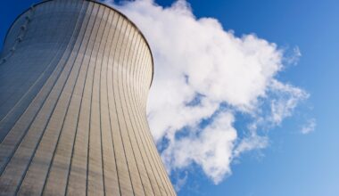 Cooling tower at nuclear power plant emits steam.