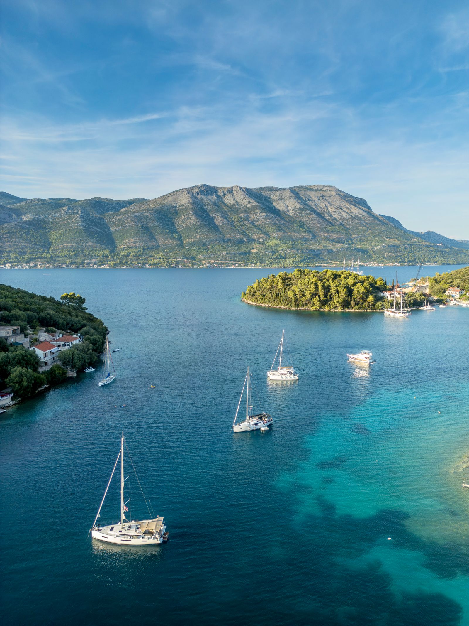 Image may contain Nature Outdoors Sea Water Boat Sailboat Transportation Vehicle Land Coast Shoreline and Yacht