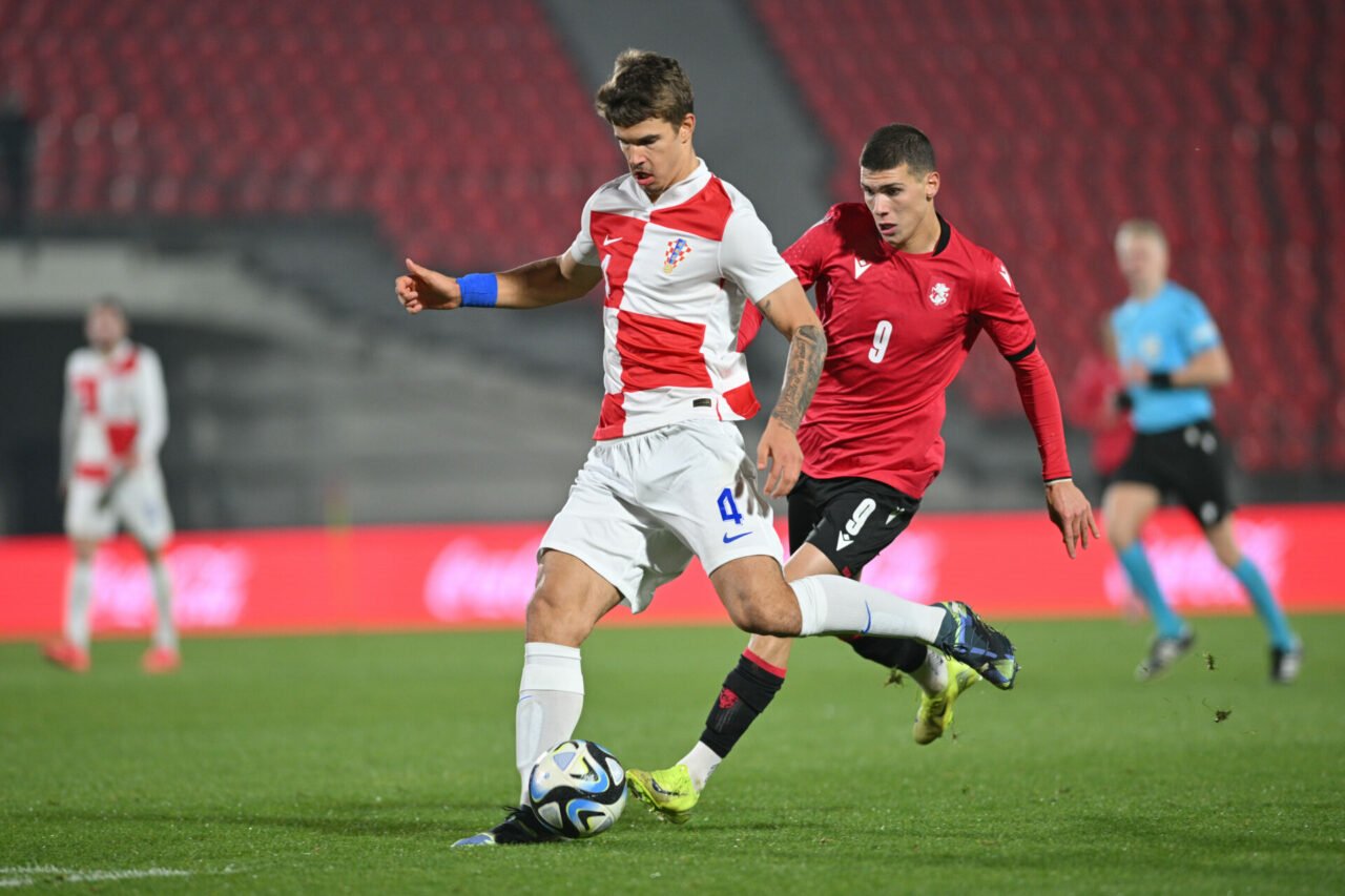 Luka Vuskovic of Croatia in action against Giorgi Kvernadze of Georgia during the UEFA Under-21 Championship Play-Off First Leg match between Georg...