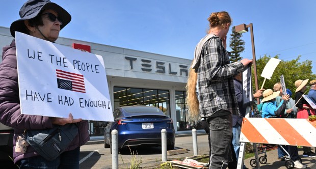 Christine Sleight of Novato stands with other demonstrators outside a...