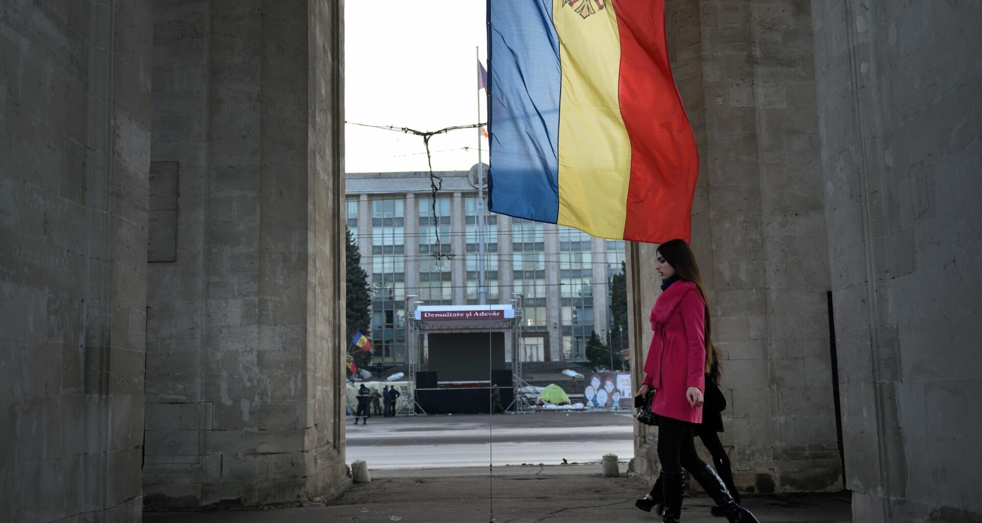 People walk under the Triumph Arch in Chisinau, Moldova.