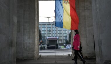 People walk under the Triumph Arch in Chisinau, Moldova.