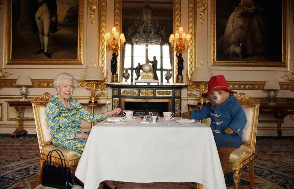 Queen Elizabeth II and Paddington Bear having tea.