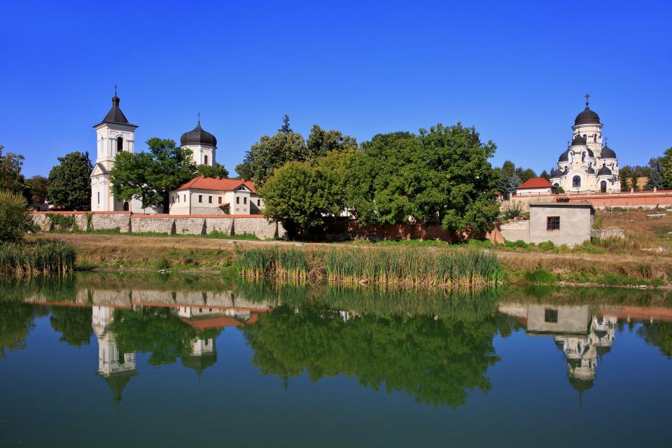 a reflection of a church in a body of water