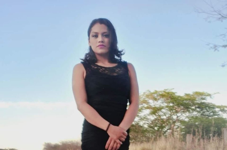 Photo of a young woman in a black dress.
