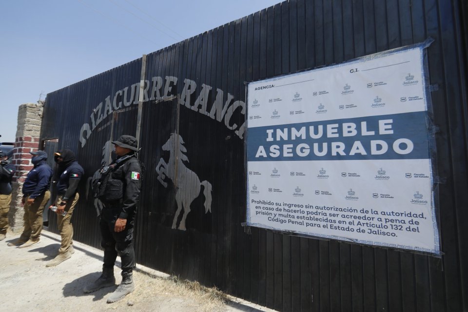 Photo of Jalisco state agents guarding the Izaguirre ranch, an alleged cartel killing site in Mexico.