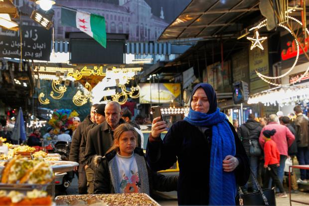 Syrians look for sweets to buy during Ramadan, the holy...