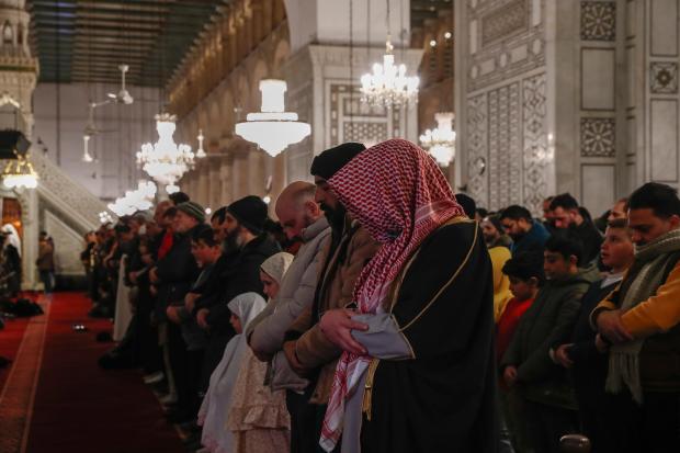 FILE.- Muslim worshippers pray on the first day of the...