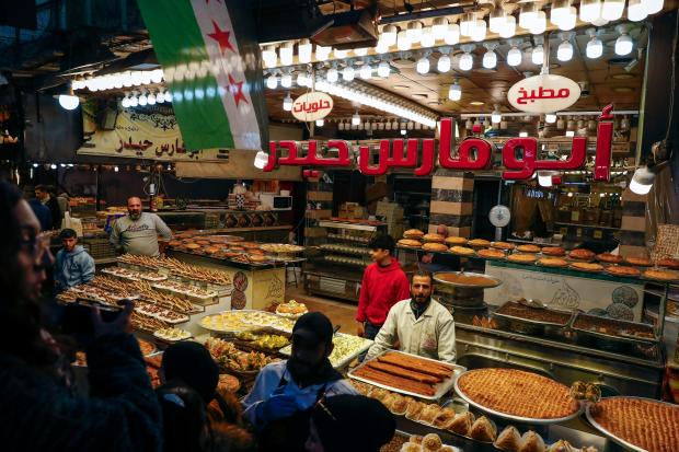 FILE.- Vendors display traditional sweets as residents shop on the...