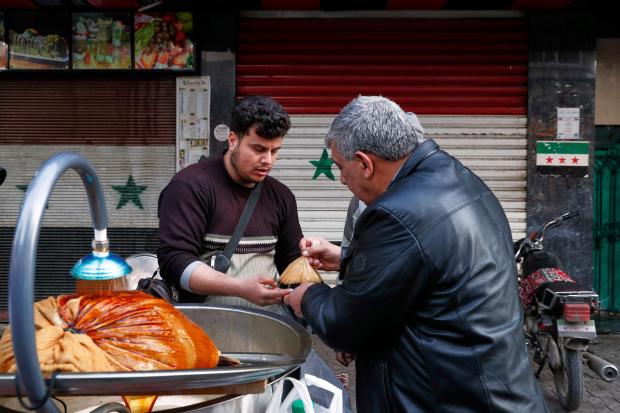 A man buys a traditional cold drink on the first...
