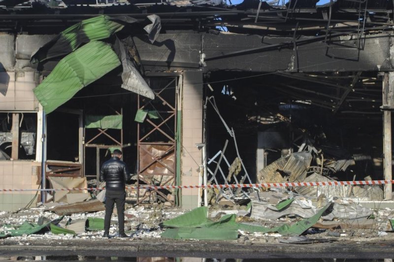 A man looks at the site of a drone attack in Odessa, South Ukraine, that damaged a hangar with agricultural machinery, a service station building, a car dealership, a four-story industrial building and a critical infrastructure object on Saturday. File Photo by Igor Tkachenko/EPA-EFE