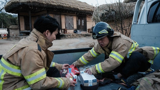 Firefighters gather ahead of the approaching wildfire in Andong Hahoe Folk Village, in Andong, South Korea, on March 25, 2025. Inhabitants of a UNESCO-listed village were ordered to evacuate while a historic Buddhist temple was burned to the ground as South Korea scrambled to contain worsening wildfires, which are tearing across the country's southeast. (AFP)