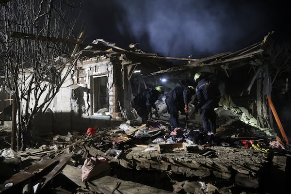 Rescue workers clear the rubble of a residential house destroyed by a Russian drone strike in Zaporizhzhia, Ukraine, Friday, March 21, 2024. (AP Photo/Kateryna Klochko)
