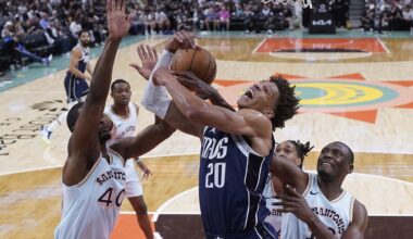 Dallas Mavericks forward Kessler Edwards (20) is blocked by San Antonio Spurs forward Harrison Barnes (40) as he drives to the basket during the first half of an NBA basketball game in San Antonio, Wednesday, March 12, 2025. (AP Photo/Eric Gay)
