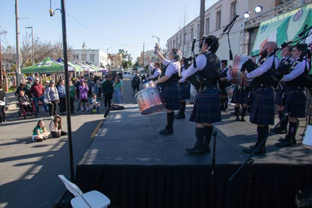 Members of the City of Angels Pipe Band perform during...