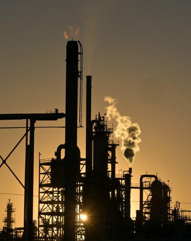 The sun sets behind Suncor Energy's oil refinery in Commerce City on Feb. 27, 2025. (Photo by RJ Sangosti/The Denver Post)