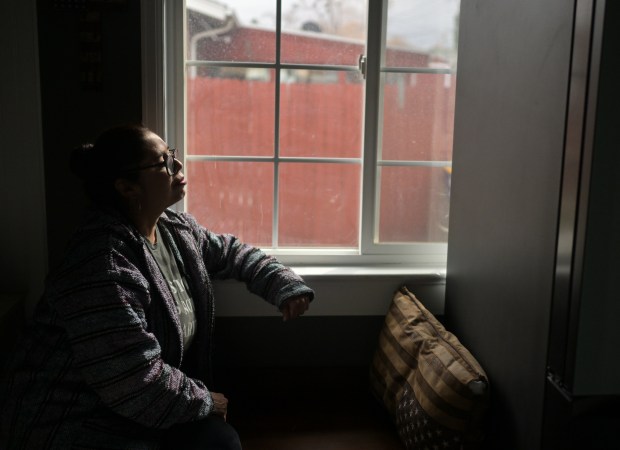 Environmental activist Lucy Molina gazes out the window of her brother's home in Lakewood on March 4, 2025. A vocal critic of Suncor Energy's oil refinery in Commerce City, Molina expresses frustration over the Colorado Department of Public Health and Environment's (CDPHE) efforts toward environmental justice for residents living near the refinery. (Photo by RJ Sangosti/The Denver Post)