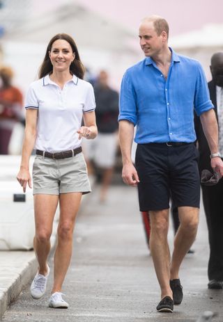 Kate Middleton and Prince William wearing shorts and smiling in the Bahamas in 2022