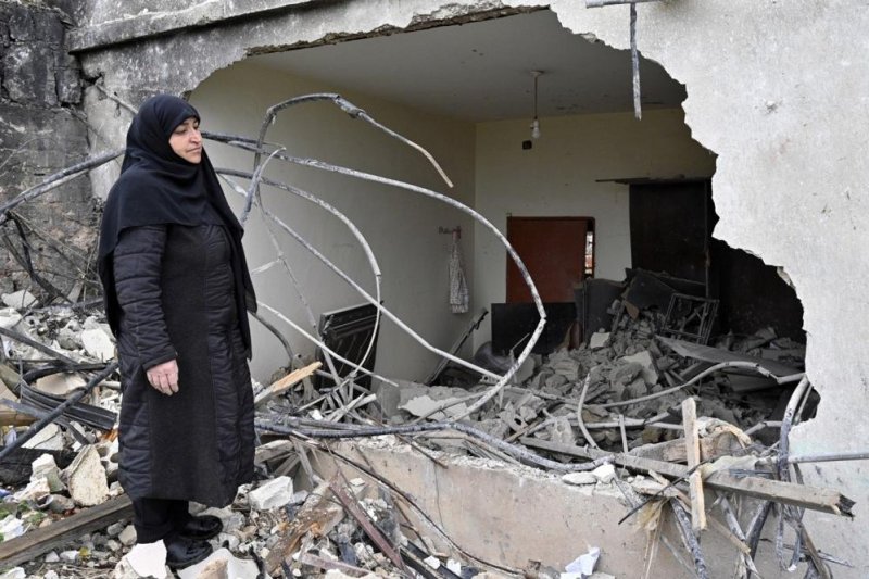 Zainab Nasrallah, 53, inspects her house, destroyed by Israeli forces, in the southern Lebanese village of Houla on Friday. Nasrallah remained in her village for nine months during the fighting between Hezbollah and Israeli forces before moving to a nearby village and then fleeing to Beirut. Now, she has returned to her village, seeking ways to rebuild her destroyed house and live there again. Photo by Wael HamzehEPA-EFE