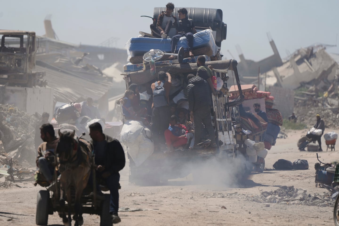 Displaced Palestinians, carrying their belongings traveling from Beit Hanoun to Jabaliya, a day after Israel's renewed offensive in the Gaza Strip, on March 19.