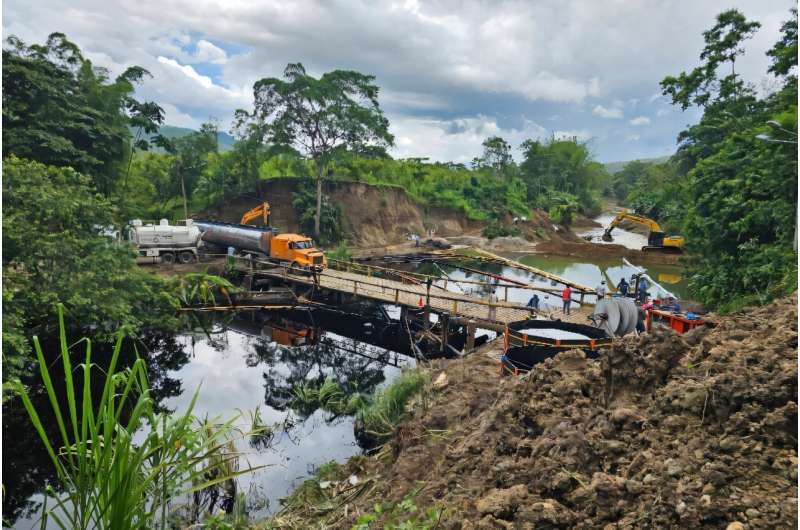 A crew works to clean up an oil spill in Ecuador