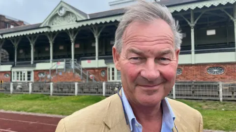BBC Rupert Lowe looks to camera wearing a tan suit after his election victory in July 2024