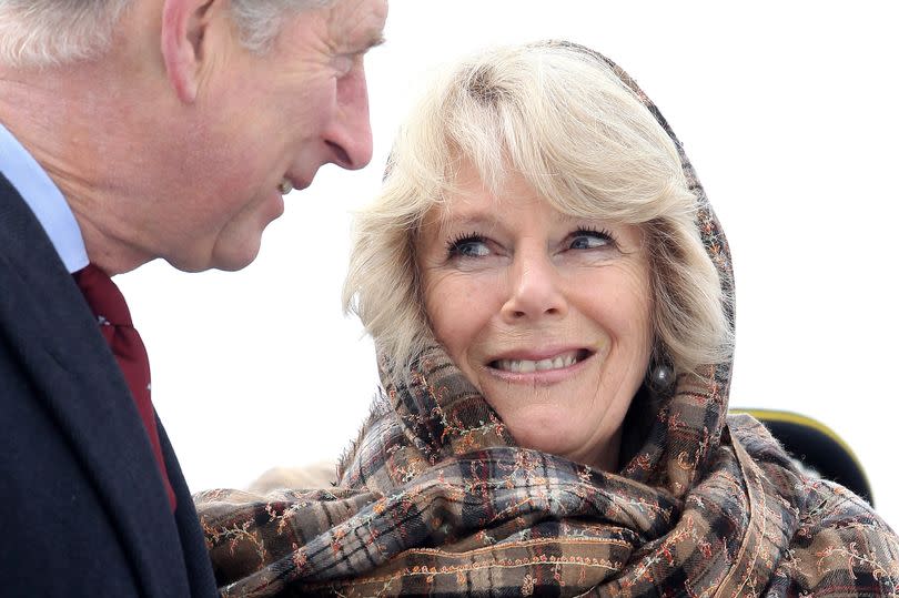 Prince Charles, Prince of Wales looks on as Camilla, Duchess of Cornwall
