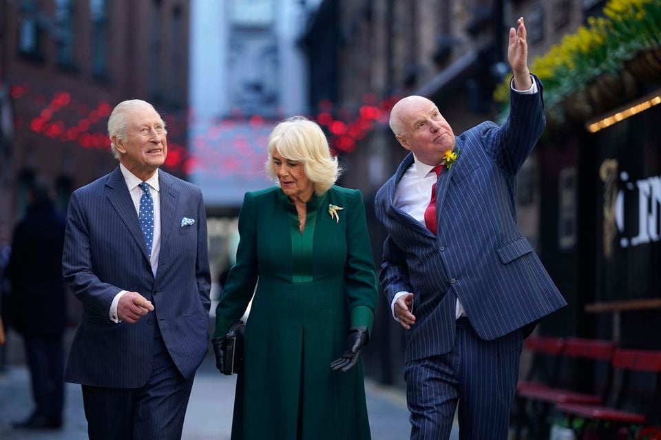 King Charles III and Queen Camilla talk to local businessman Willie Jack (right). Niall CarsonPA Wire