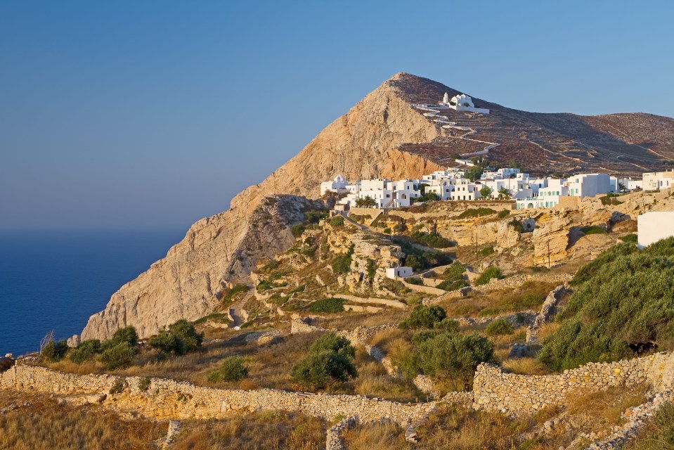 Folegandros island capital town perched on a steep cliff overlooking the Aegean sea.