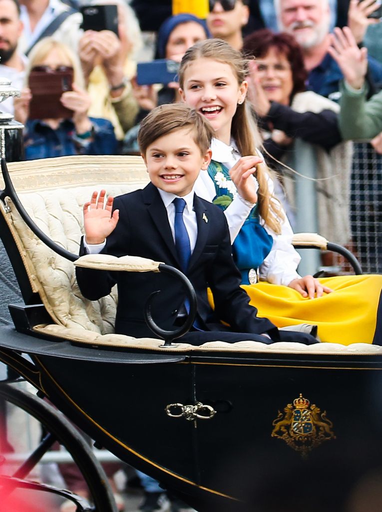 brother and sister riding in carriage