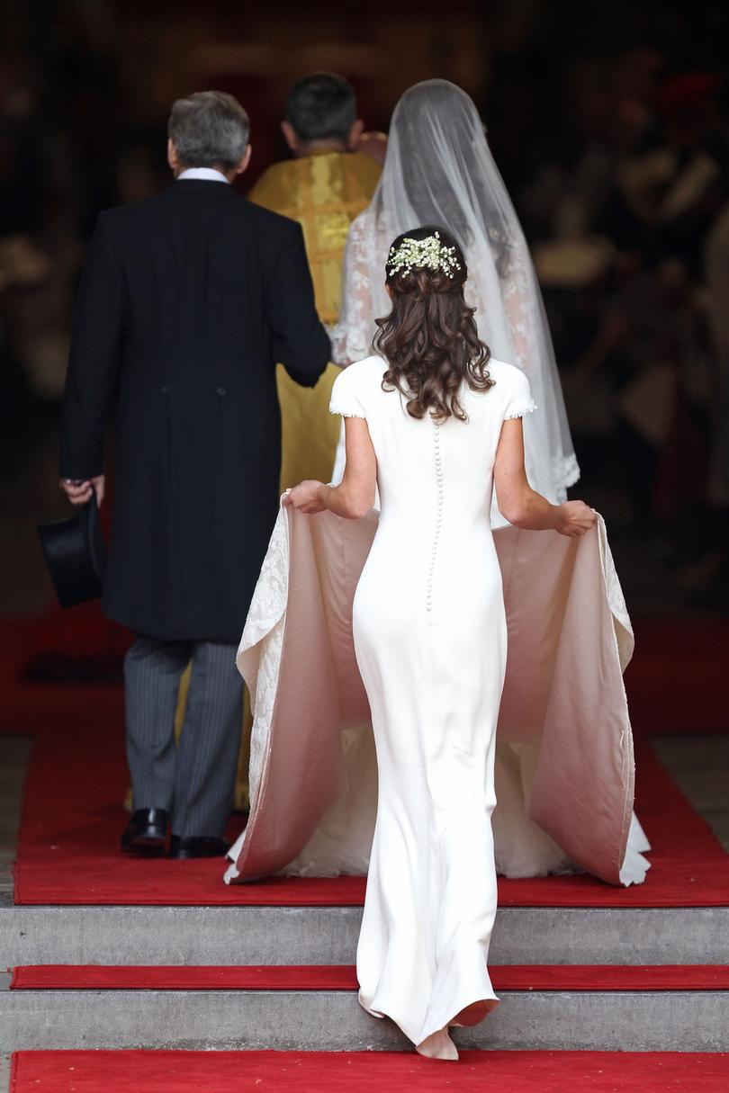 Pippa appeared in a body-hugging white gown as she helped Kate down the aisle as her maid of honour. 