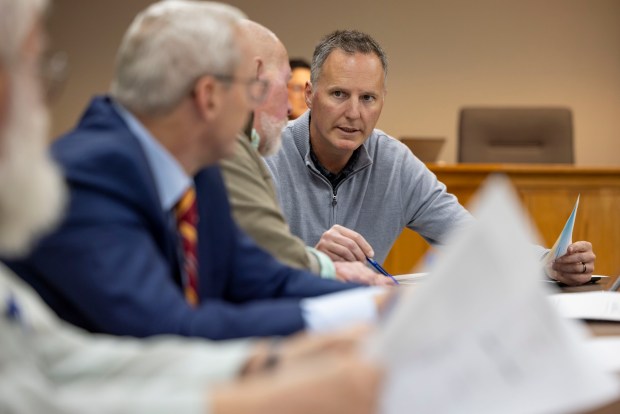 Matt Baumann, of Equinix, discusses his company's plans for a data center during a Minooka village board committee meeting on March 19, 2025. "I would love to not be in limbo right now, trust me," Baumann, the company's real estate director for the Americas, said in an interview. Still, he described the approval processes he's encountered in Minooka and the rest of Illinois as "fairly standard.'' (Brian Cassella/Chicago Tribune)