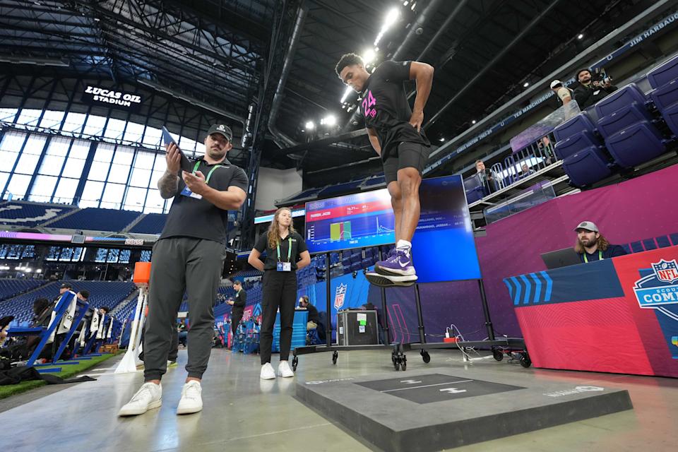 Feb 28, 2025; Indianapolis, IN, USA; Hawkins Dynamics specialists Trent Bassingthwaite (left) and Cat Moss (center) record force plate measurements for Kansas State defensive back Jacob Parrish (DB24) during the 2025 NFL Scouting Combine at Lucas Oil Stadium. Mandatory Credit: Kirby Lee-Imagn Images