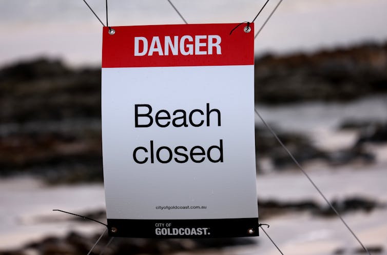 beach closed sign in queensland.