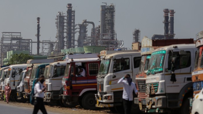 Lorries lined up in front of an Indian refinery complex