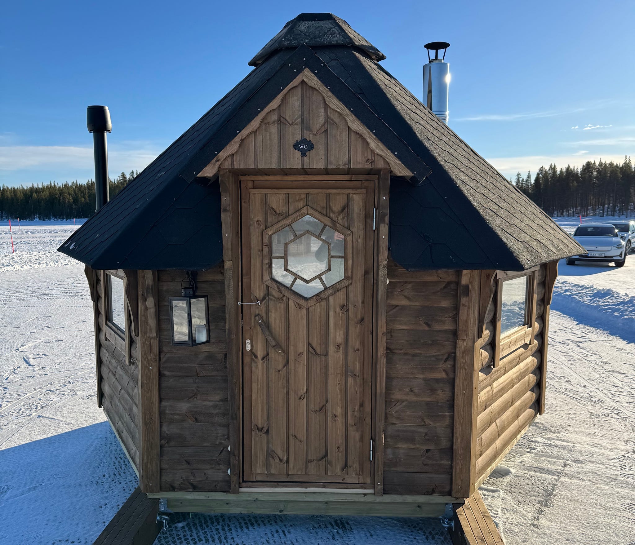wooden cabin designed for outdoor use featuring a distinctive roof and chimney